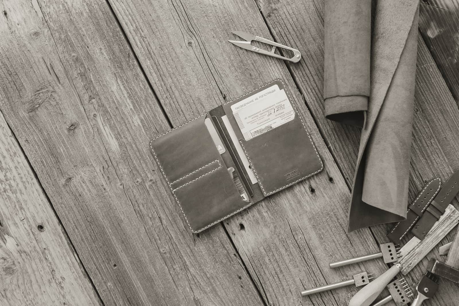 Car keys and a wallet laid out on a wooden workbench