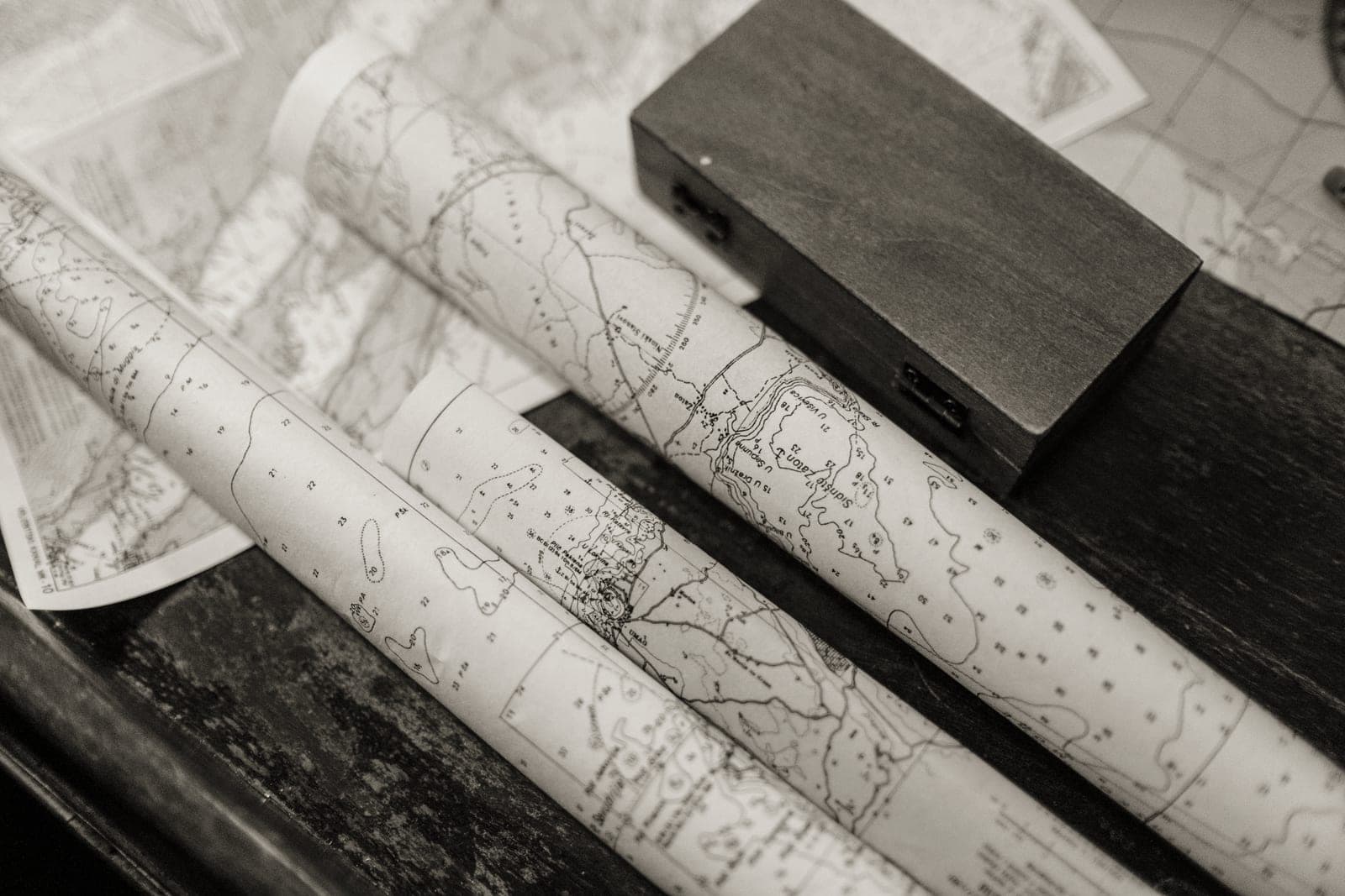 Rolled paper maps on an outdoor table