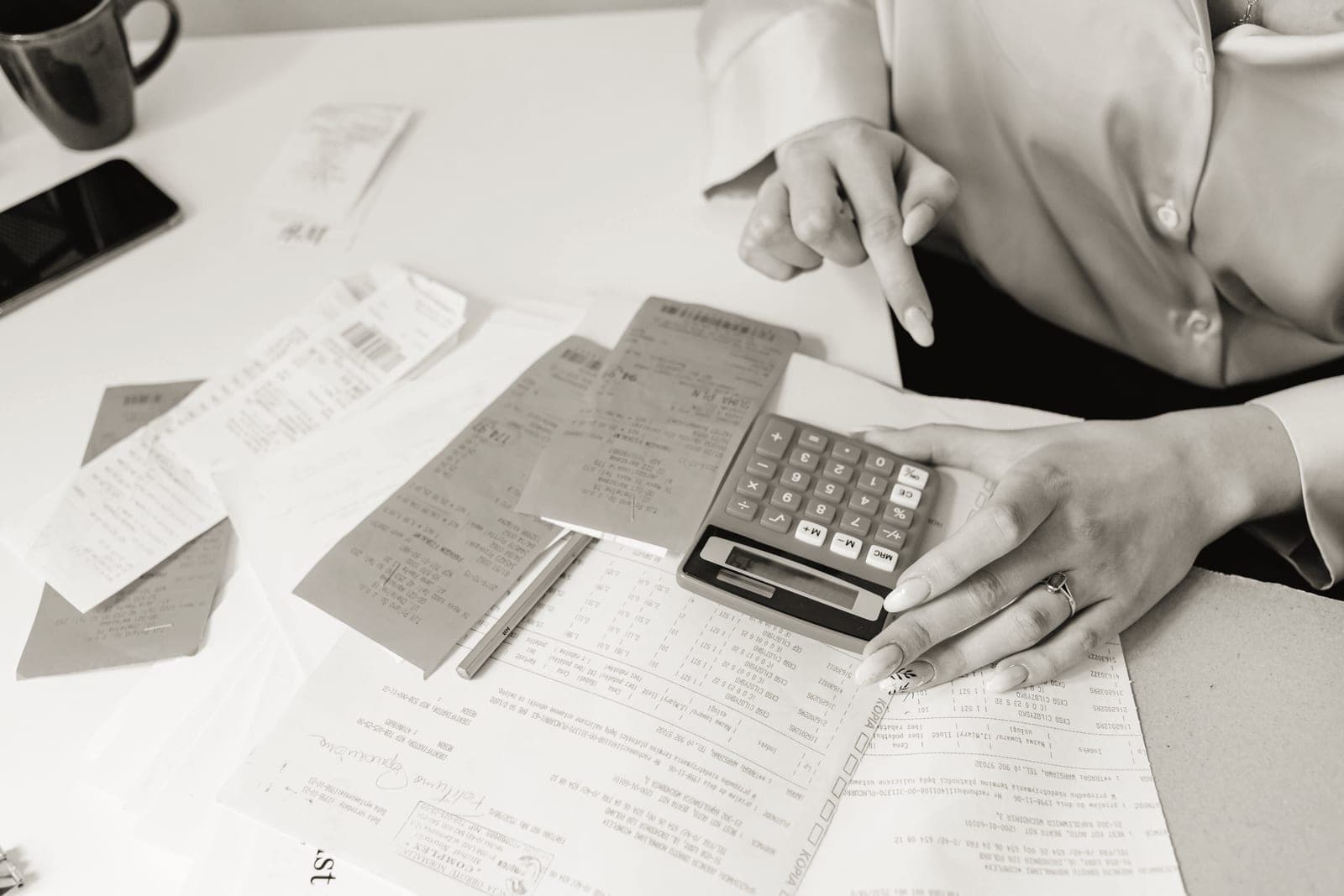 Receipts and a calculator on a wooden desk